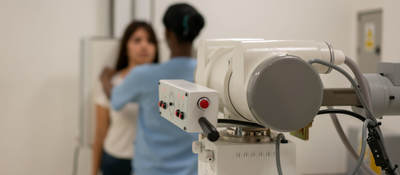 Nurse aligning a patient in order to take an x-ray
