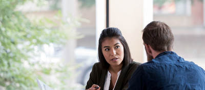 Two people discussing a document
