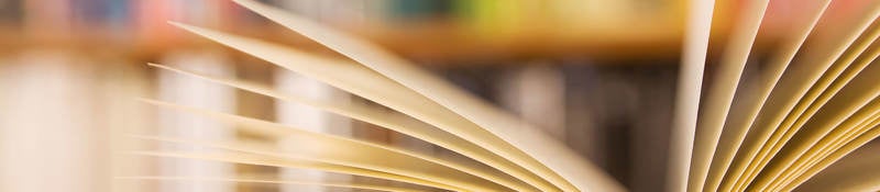 Book laying open on a table in a library