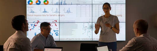 Meeting in front of a large information device about universal detection of genes in a specific biological sample.