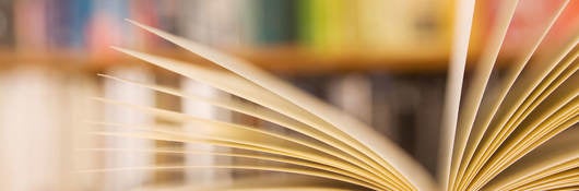 Book laying open on a table in a library