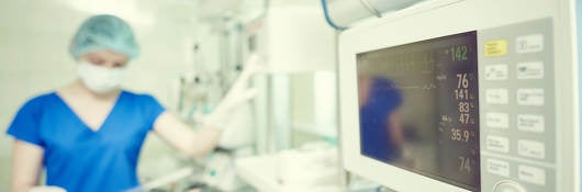 Surgery and intensive care unit. Female doctor or nurse in surgical child neonatal hospital with artifical lung ventilation device