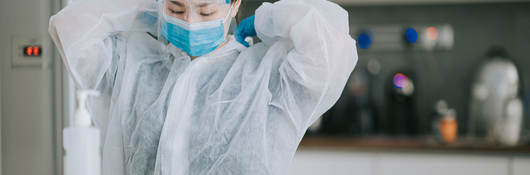 Scientist putting on PPE