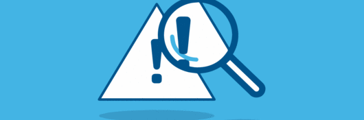 Magnifying glass looking at triangular warning icon