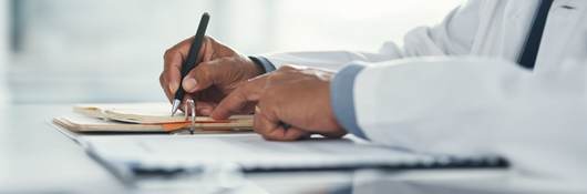 Healthcare professional drafting a medical insurance letter, legal paperwork or form.