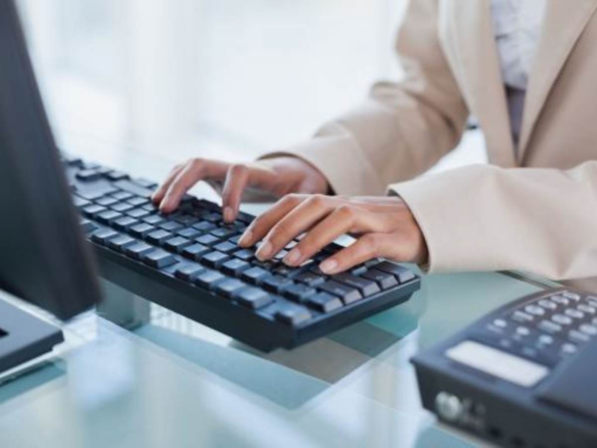 Hands typing on a keyboard.