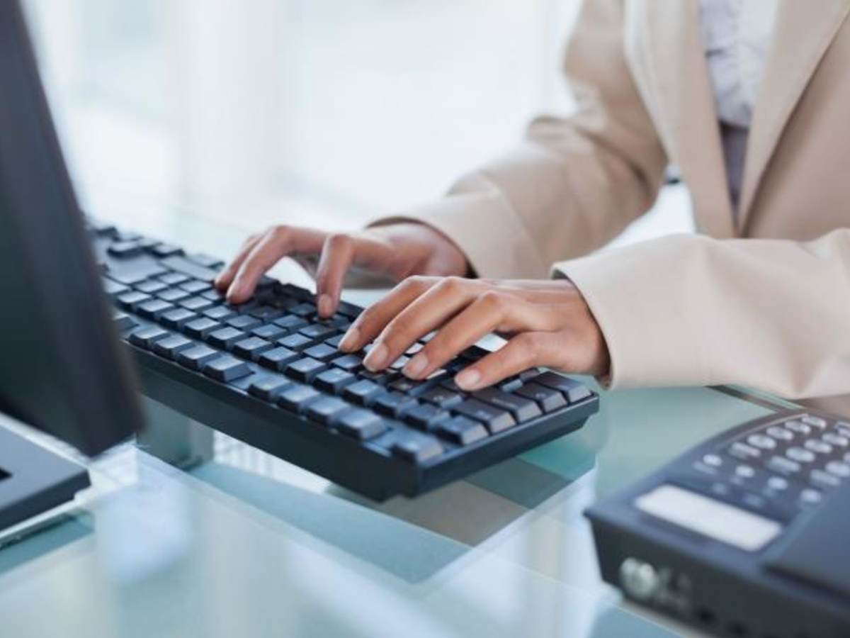 Close up of a person typing on a keyboard