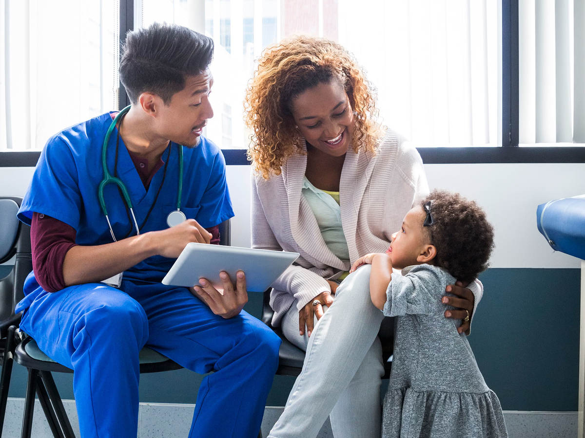 A nurse talking to a mother and child