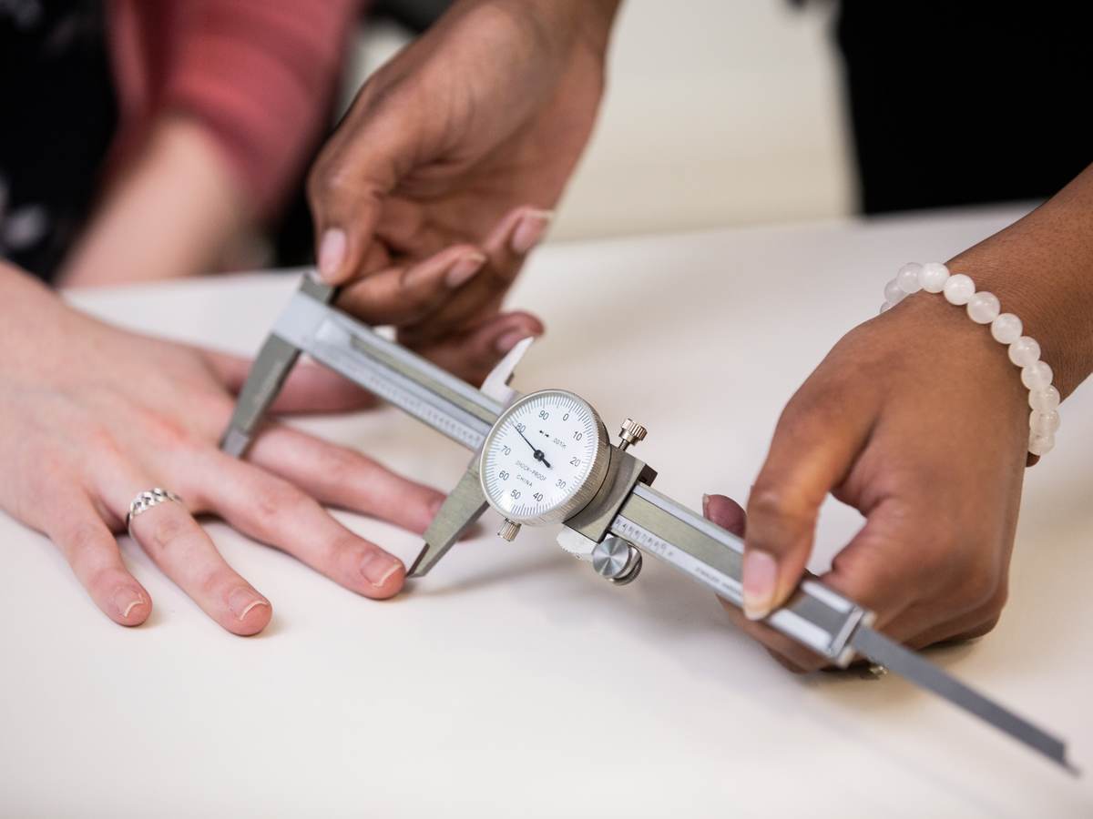 Doctor measuring the length of a patient's finger