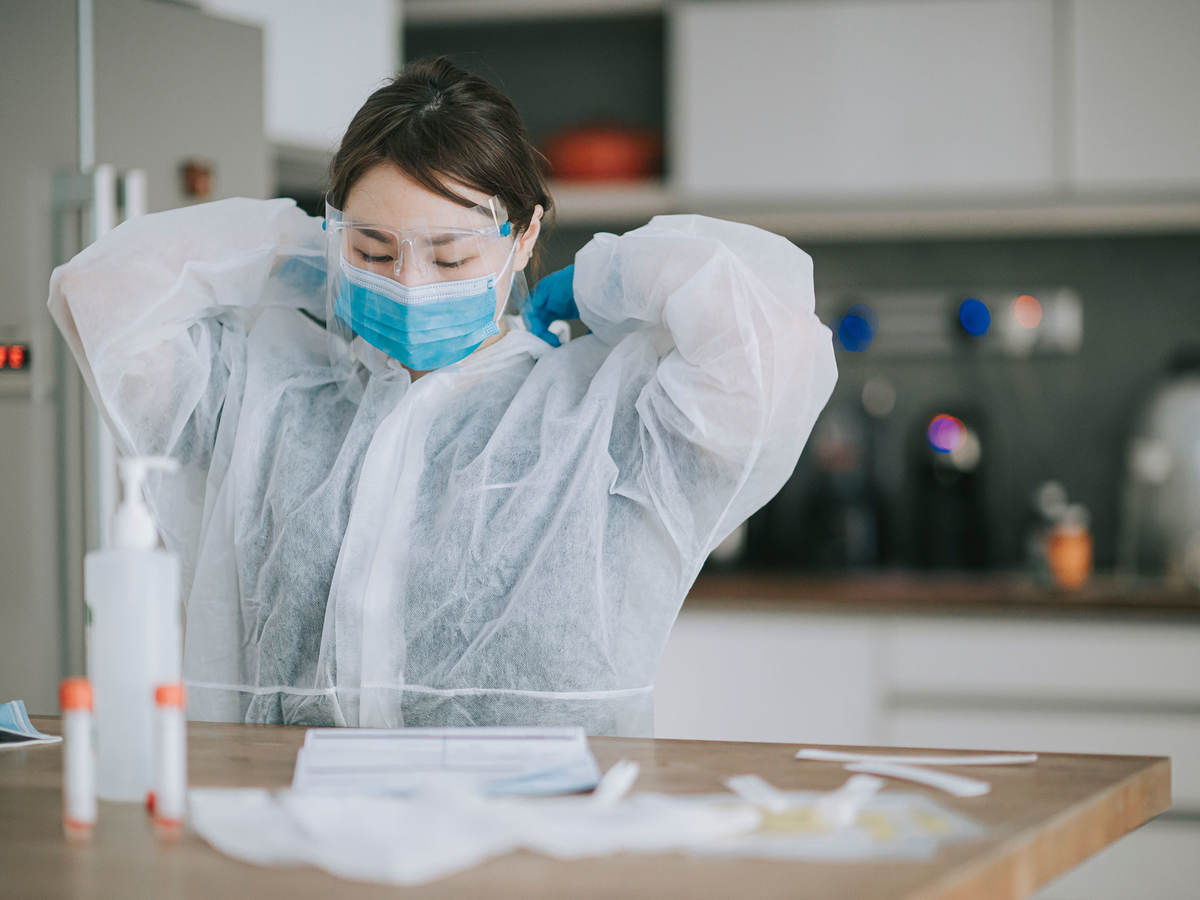 Scientist putting on PPE
