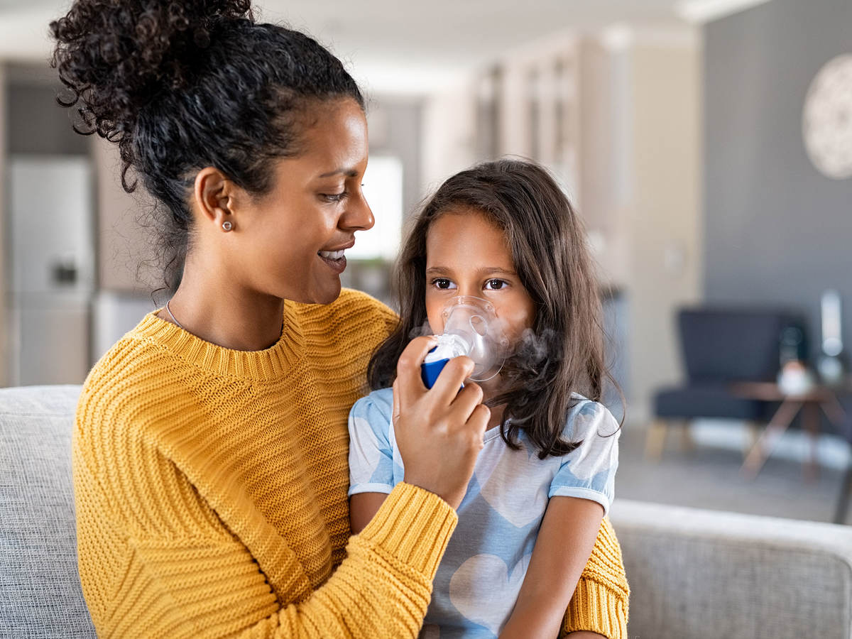 Person giving a child oxygen