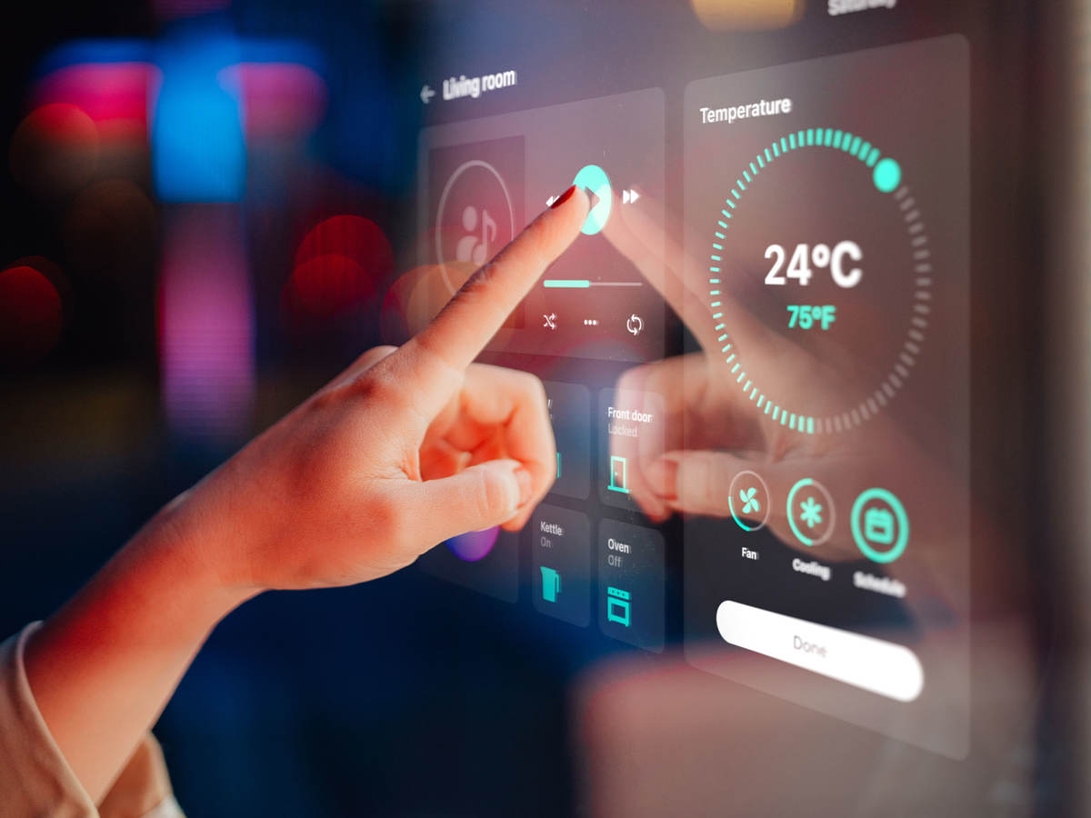Person pressing Play on a touch screen
