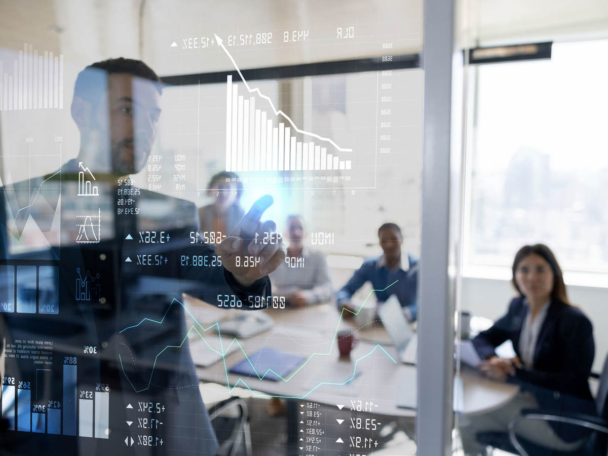 Person in a business meeting using an interactive screen while giving a presentation