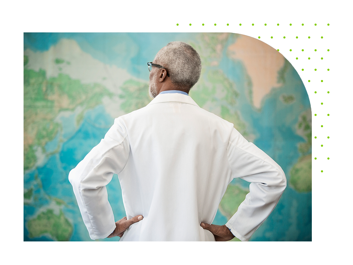 A doctor looking at a large map on the wall